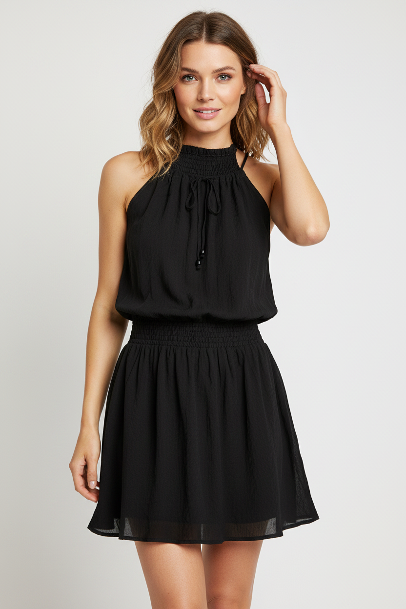 Model wearing black halter mini dress with smocked neckline
