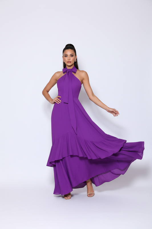 Model wearing purple halter maxi dress with ruffles